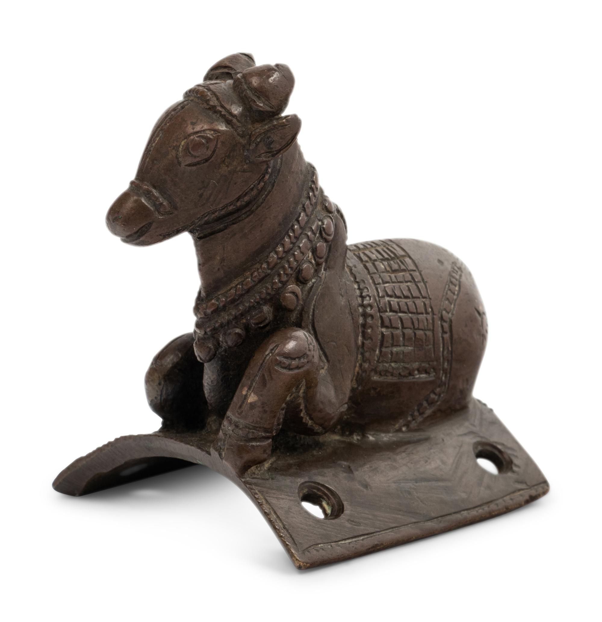 A Small Indian Bronze Figure of a Recumbent Bull