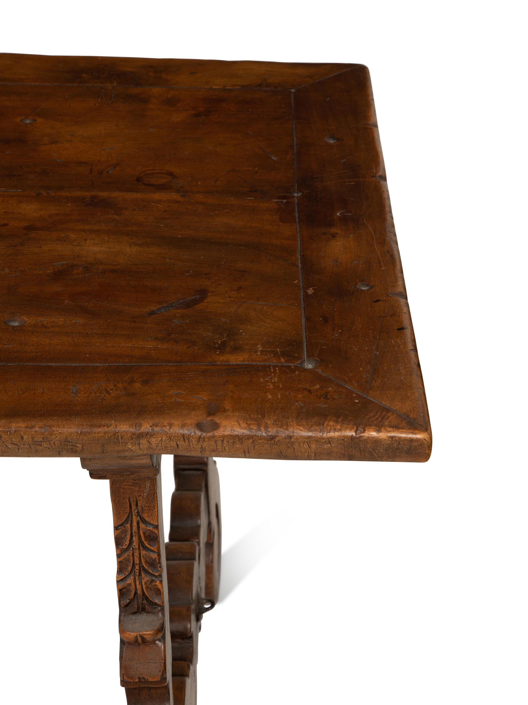 A Spanish Walnut and Wrought Iron Trestle Table