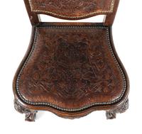 A Pair of Portuguese Carved Walnut and Tooled Leather Hall Chairs