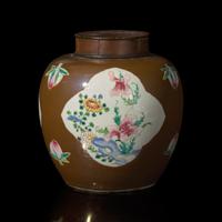 A Chinese Café-au-Lait Ground Famille Rose Jar, 18th Century — 清中期 烏金地開光粉彩花卉罐