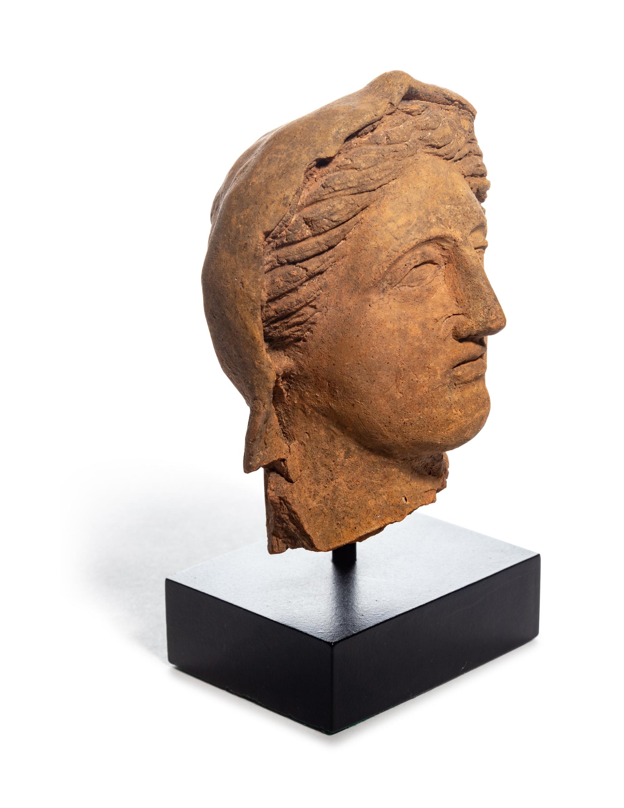 An Etruscan Terra Cotta Votive Head of a Woman