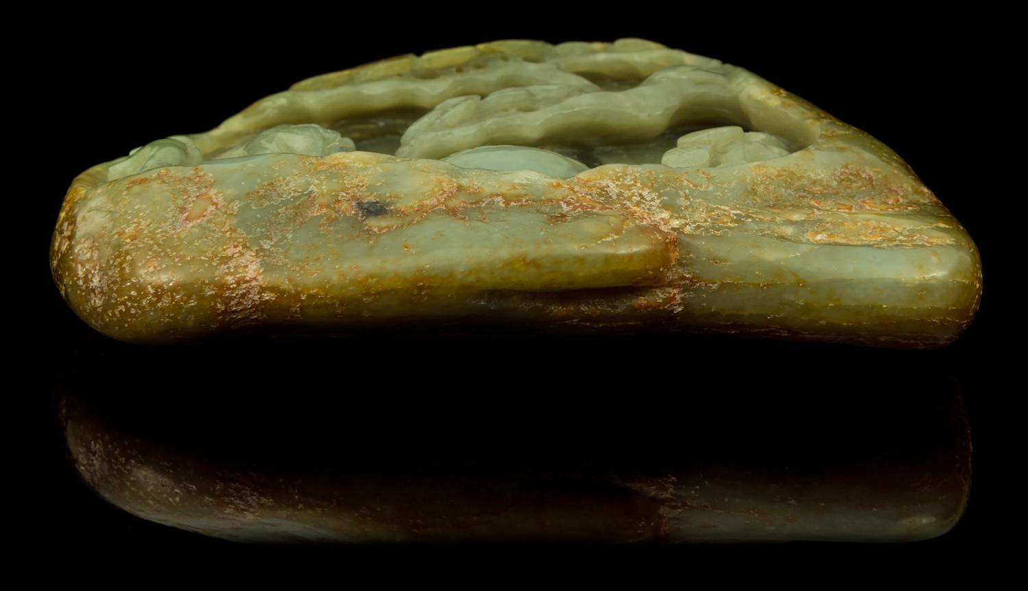 A Carved Celadon Jade Boulder Height 4 1/8 x width 5 1/2 inches.