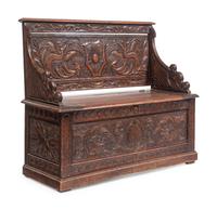 An Italian Renaissance Revival Carved Oak Settle