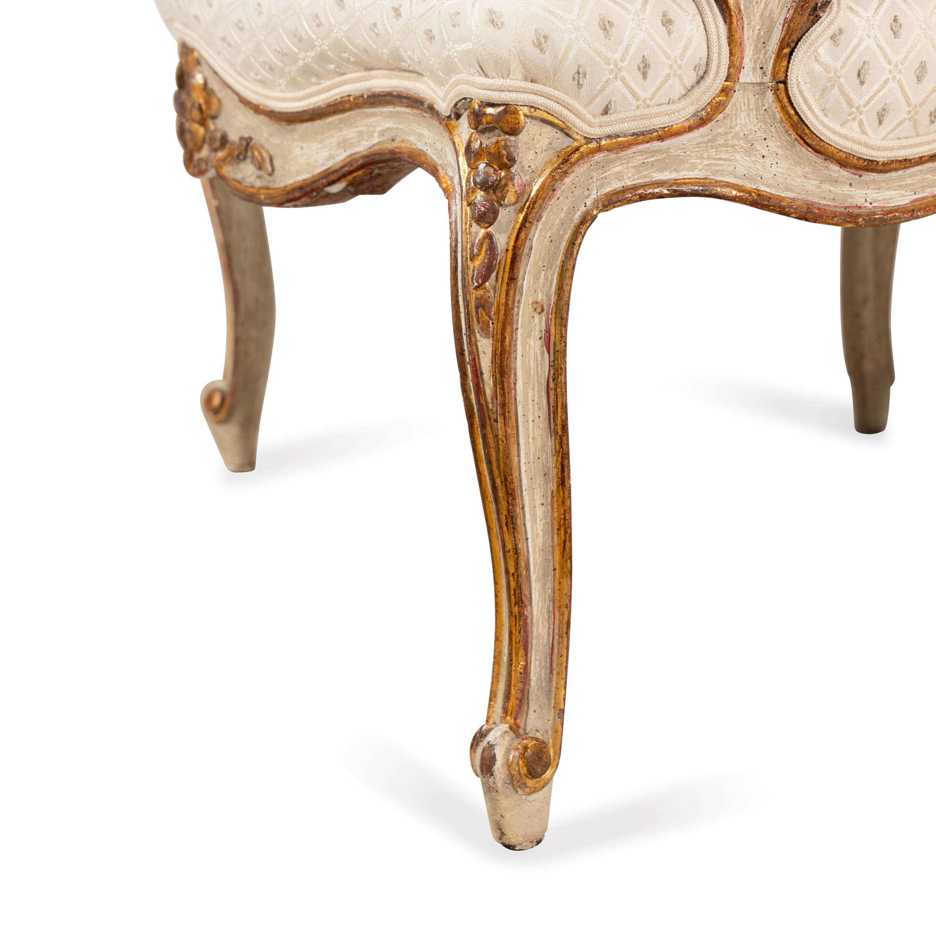 A Pair of Louis XV Style Painted and Parcel Gilt Fauteuils
