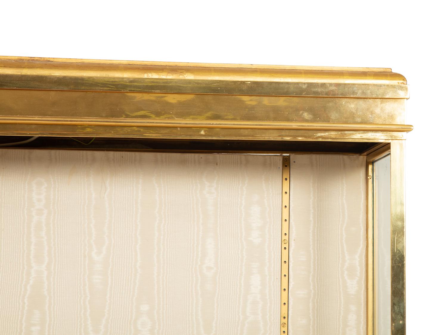An English Brass Vitrine Cabinet on a Giltwood Base
