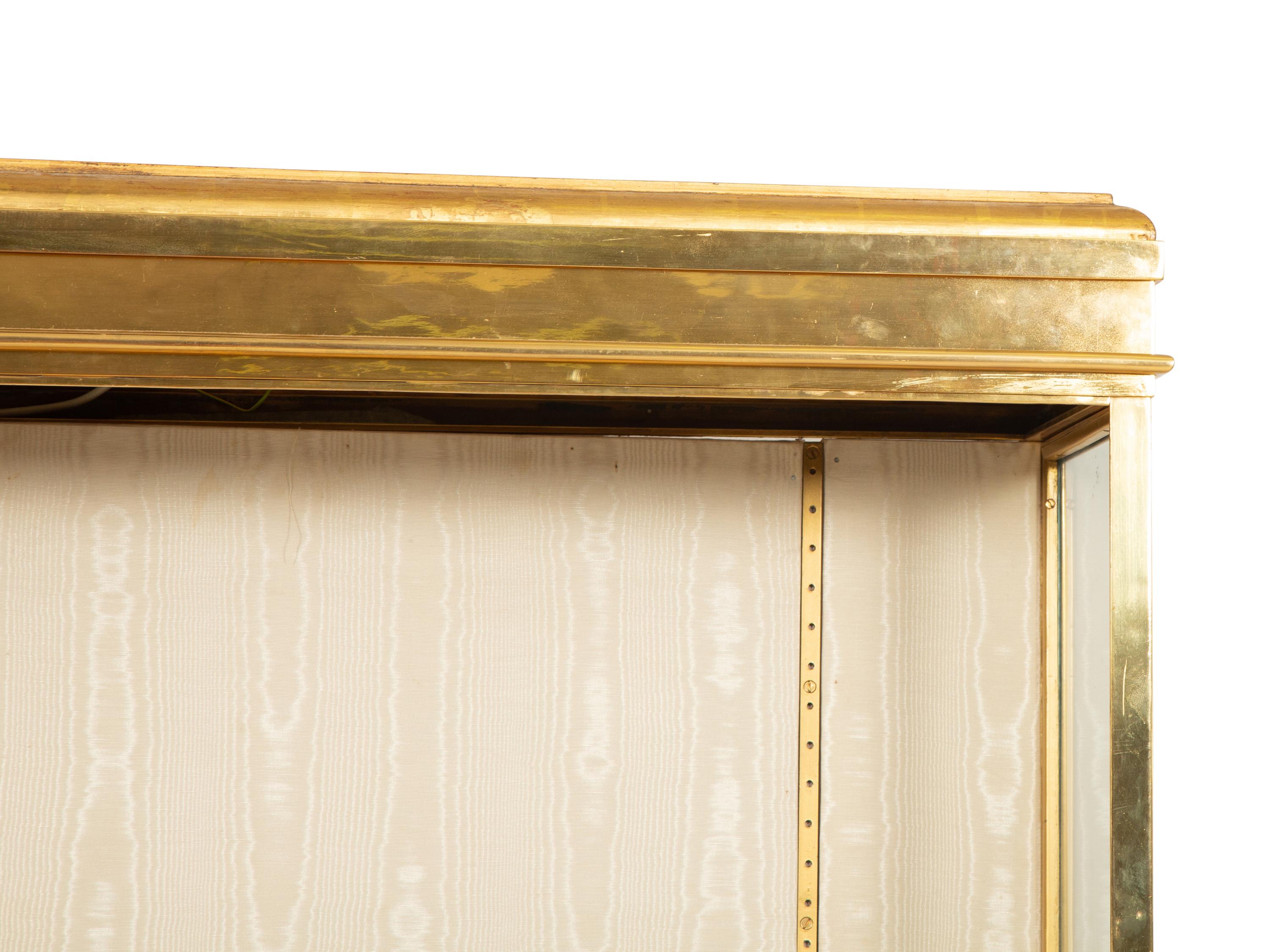 An English Brass Vitrine Cabinet on a Giltwood Base