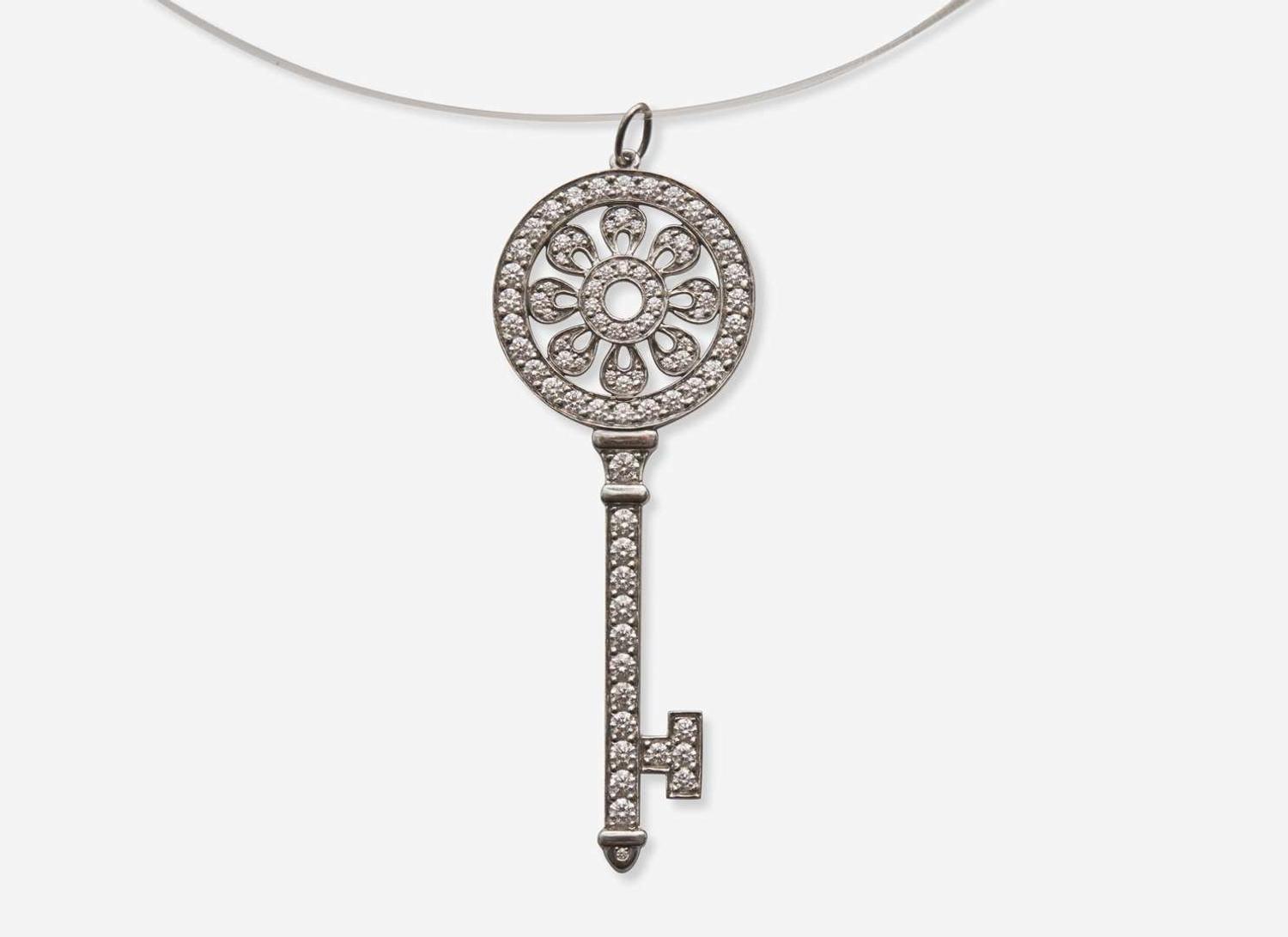 A Platinum and Diamond Tiffany & Co. Petals Key Pendant on a Sterling Silver Lalique Cord