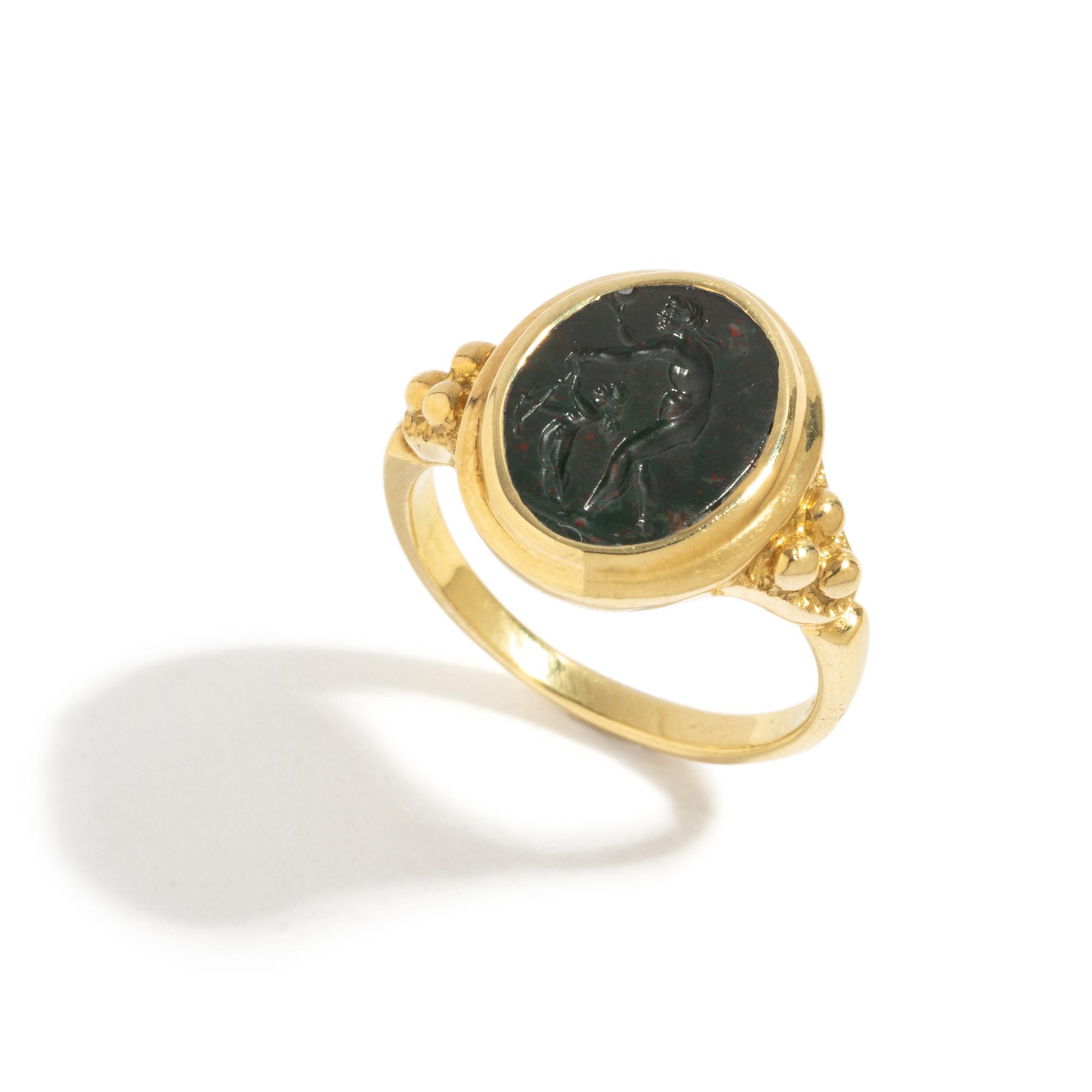 A Roman Bloodstone Double-Sided Ring Stone with the Gods Venus and Eros & a Portrait Head of a Deity — Set in a gold ring, '18k' stamped on inside