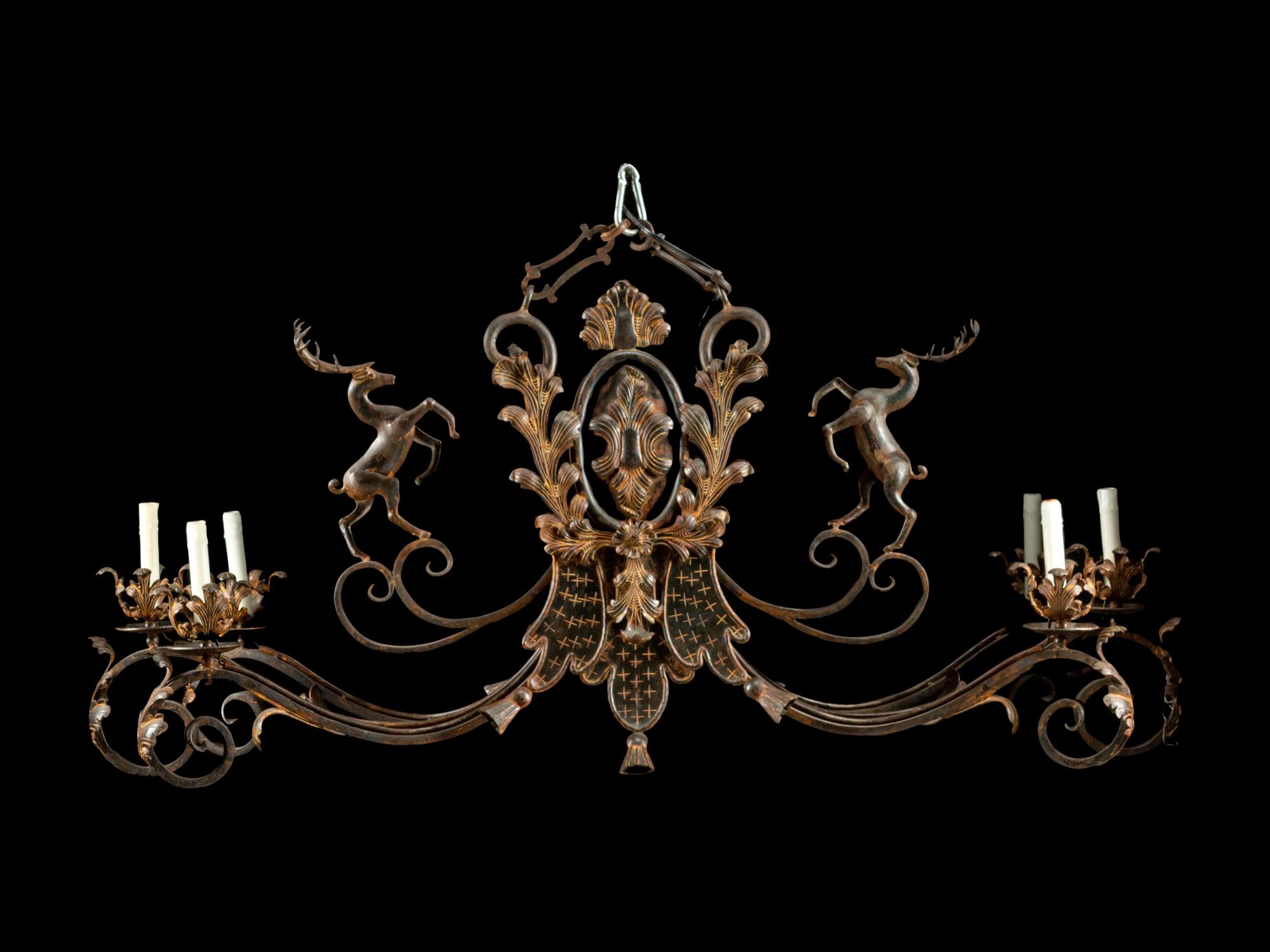 A Wrought Iron and Tôle Six-Light Chandelier