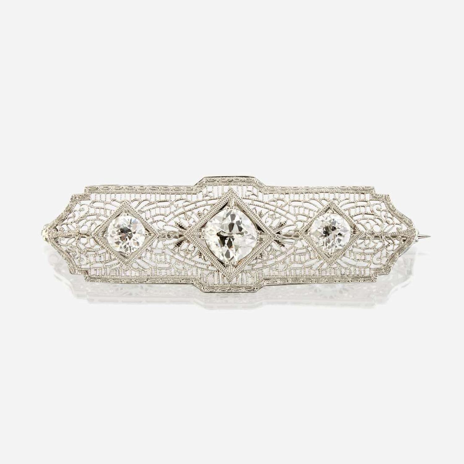 A diamond and ten karat white gold brooch