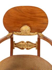 A Pair of Baltic Neoclassical Parcel-Gilt Walnut Armchairs