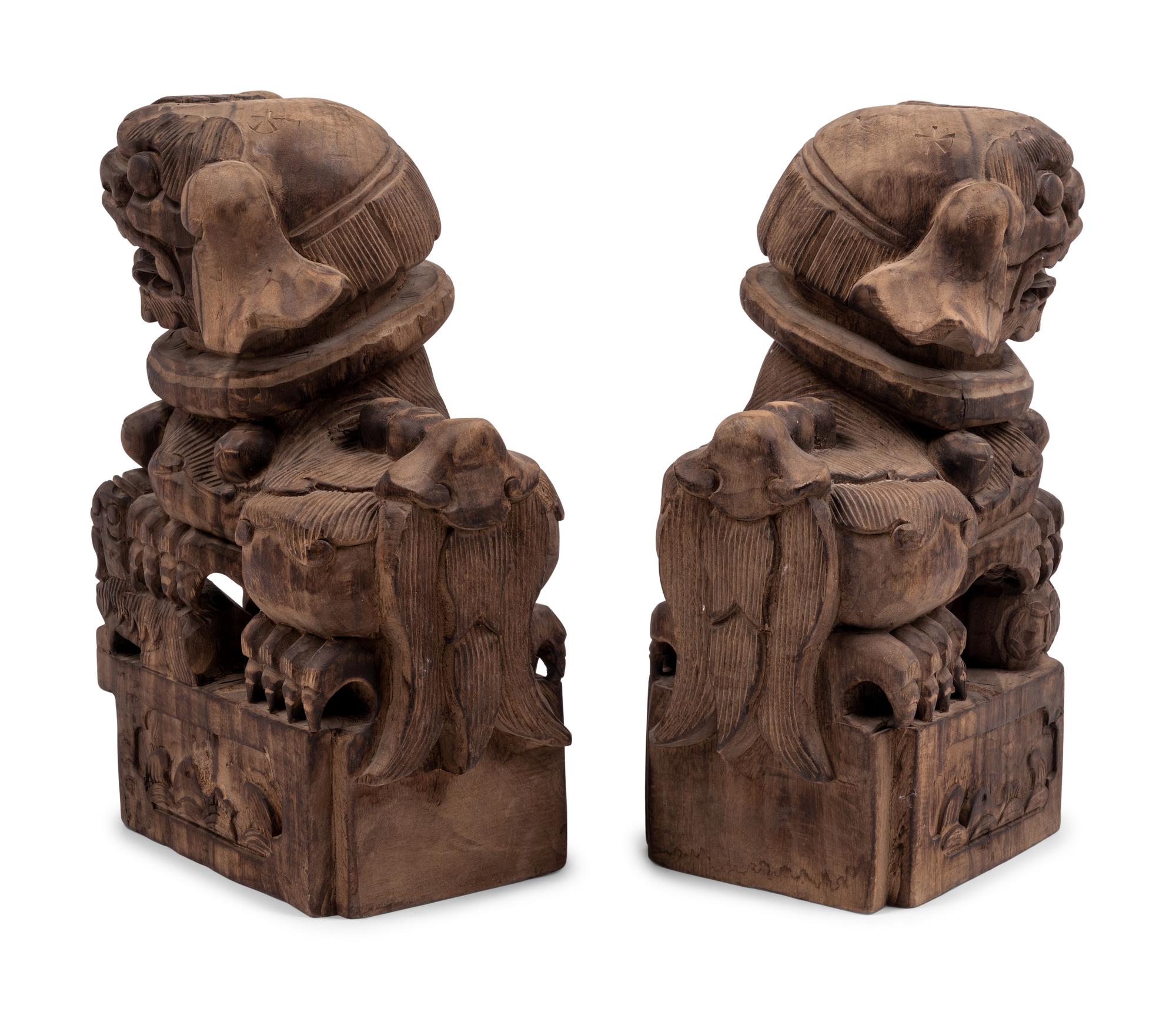 A Pair of Carved Wood Buddhistic Lions
