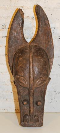 A Senufo Cow Masque. Height 32 x width 14 inches.