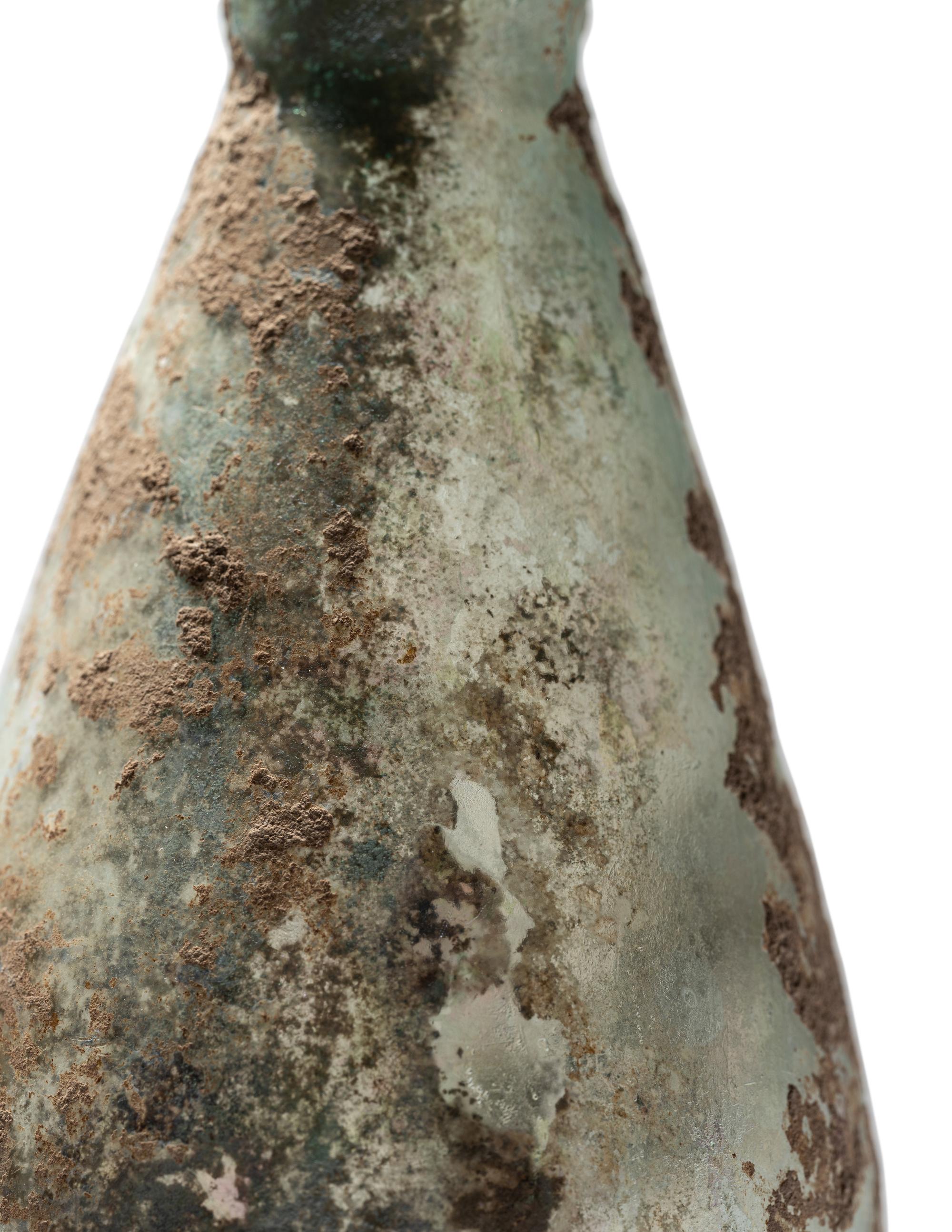 A Roman Pale Blue Glass Unguentarium