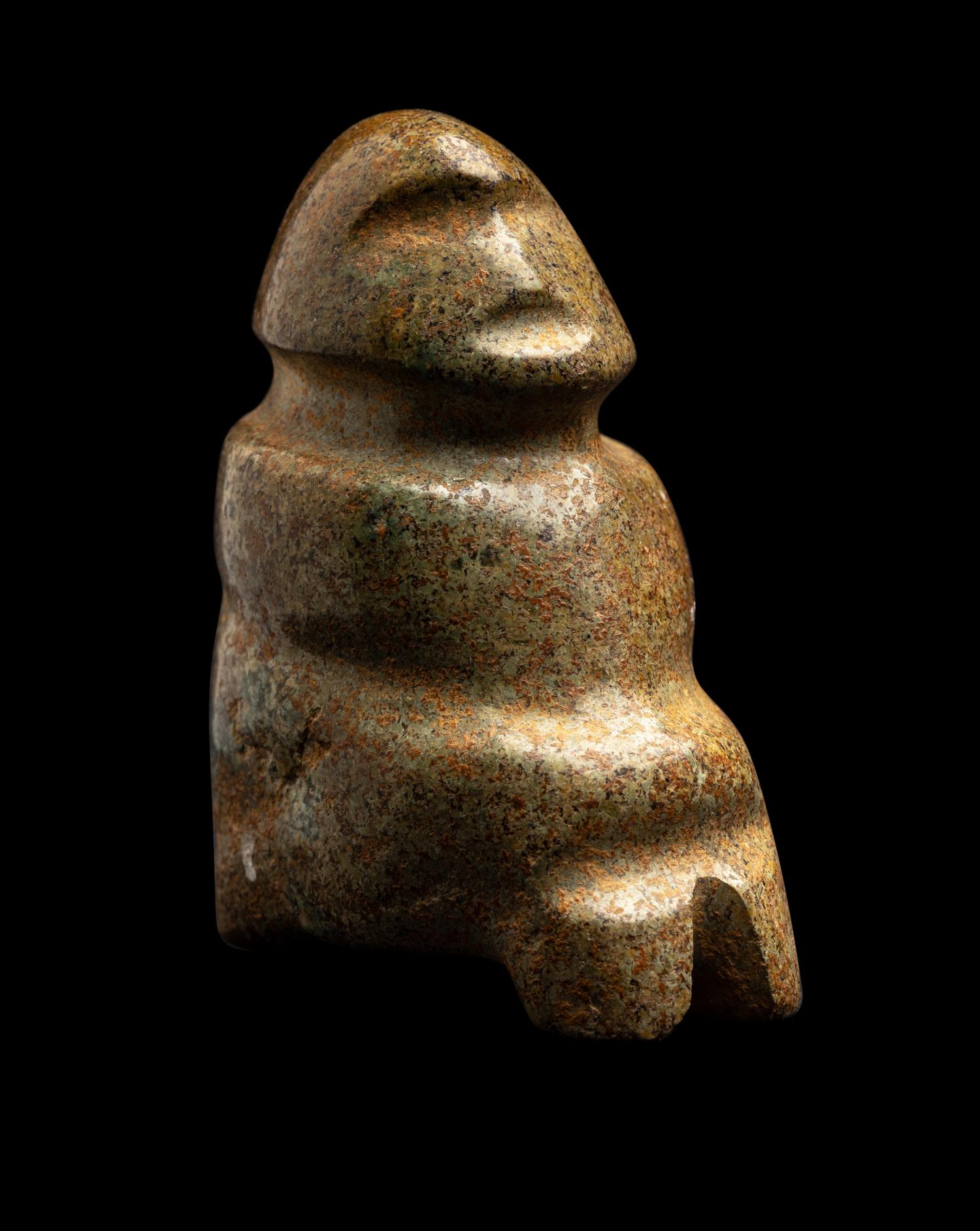 A Mezcala Green-White Stone Seated Figure