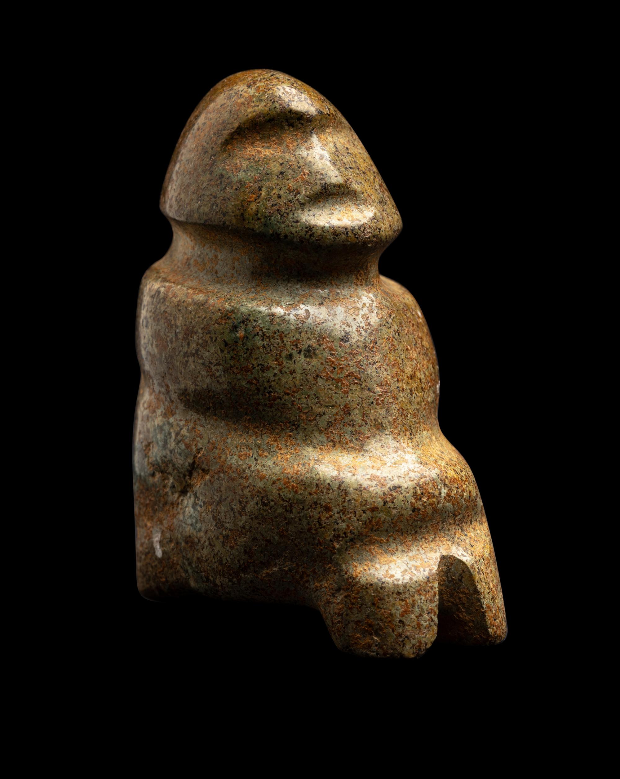 A Mezcala Green-White Stone Seated Figure