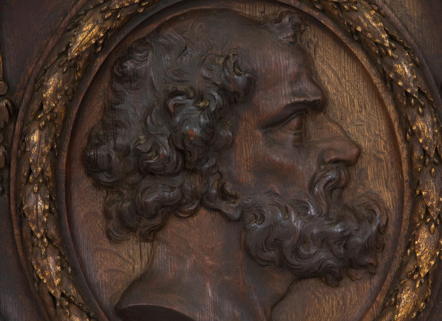 A Pair of Continental Carved Oak and Parcel Gilt Profile Plaques