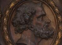 A Pair of Continental Carved Oak and Parcel Gilt Profile Plaques