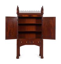 A Gothic Style Carved Mahogany Cabinet with P.E. Guerin Hardware