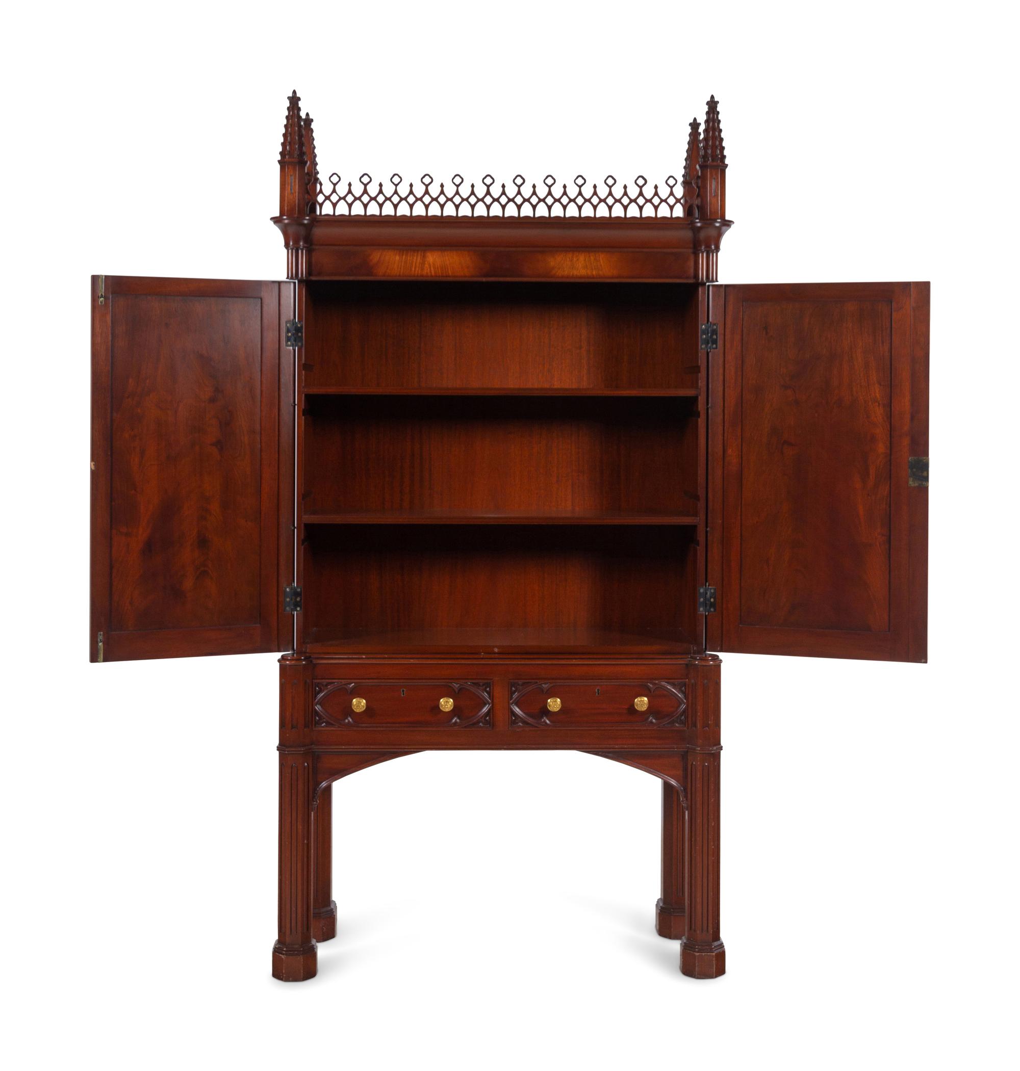 A Gothic Style Carved Mahogany Cabinet with P.E. Guerin Hardware