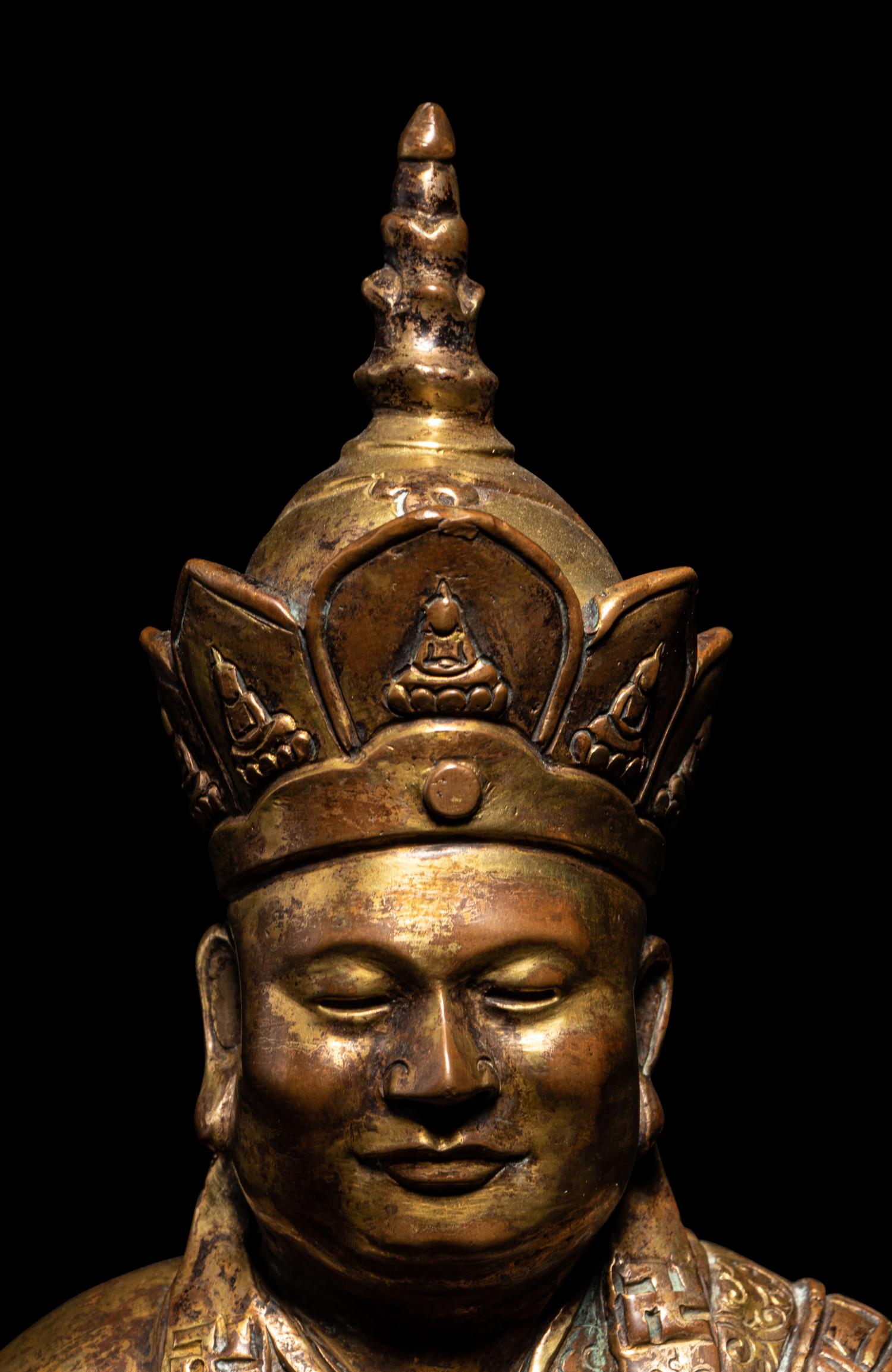 A Tibetan Gilt Bronze Figure of a Seated Guru