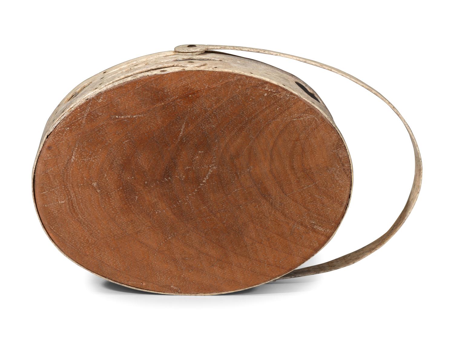 A Carved and Pierced Whale Bone Swing-Handle Basket