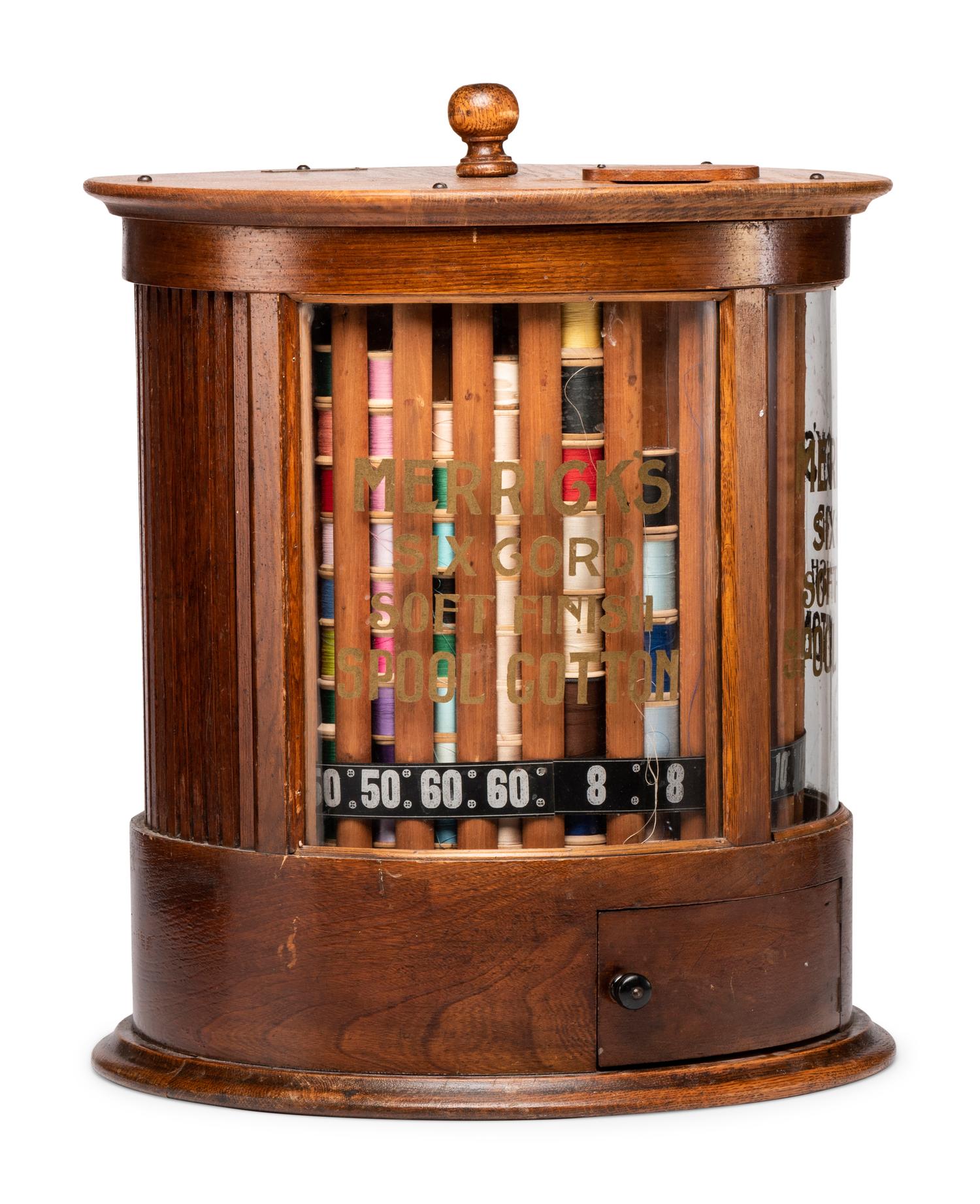A Merrick's Six Cord Cylindrical Oak Spool Cabinet