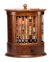 A Merrick's Six Cord Cylindrical Oak Spool Cabinet