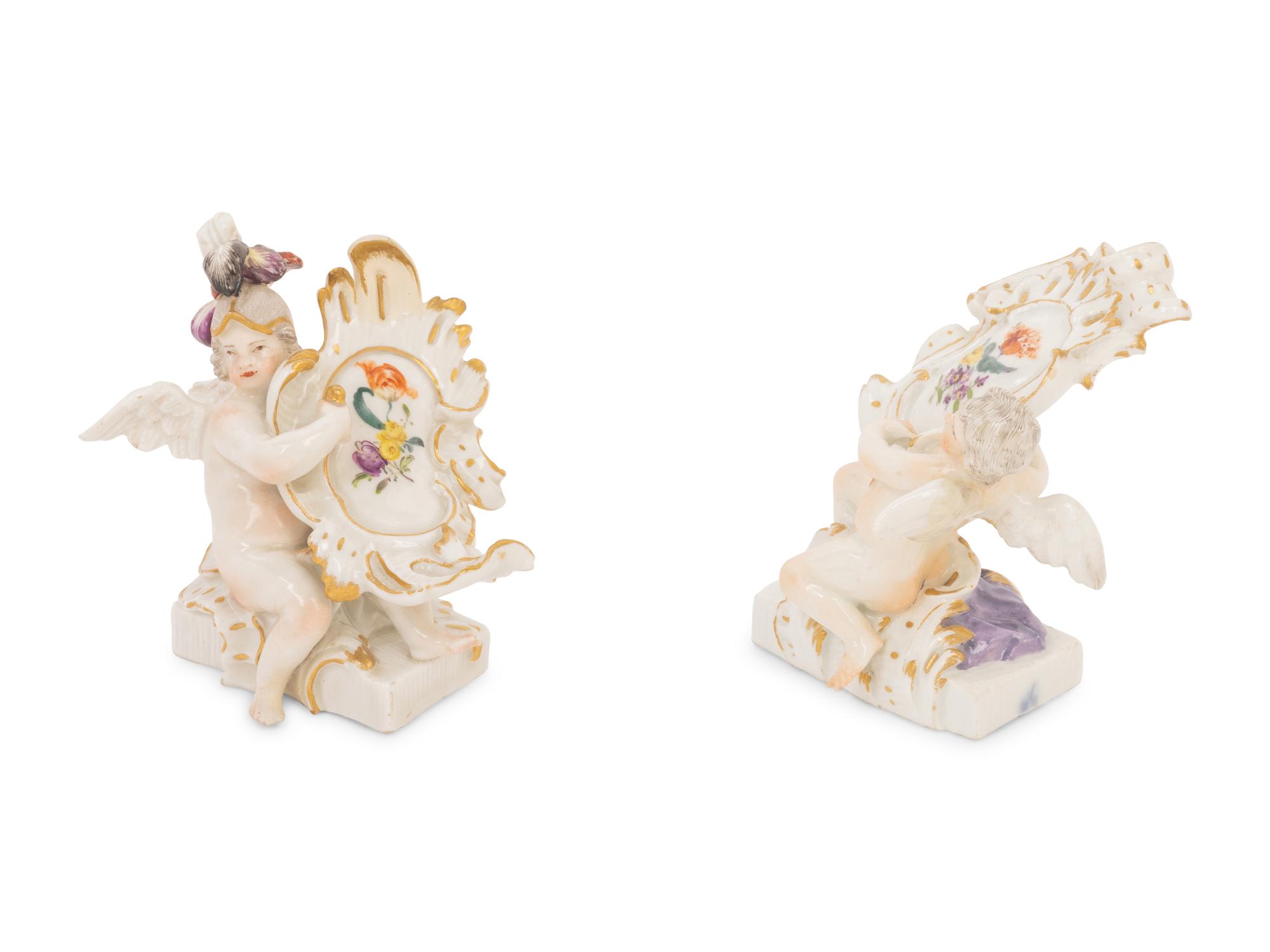 A Pair of Meissen Porcelain Figures of Putti with Cartouches