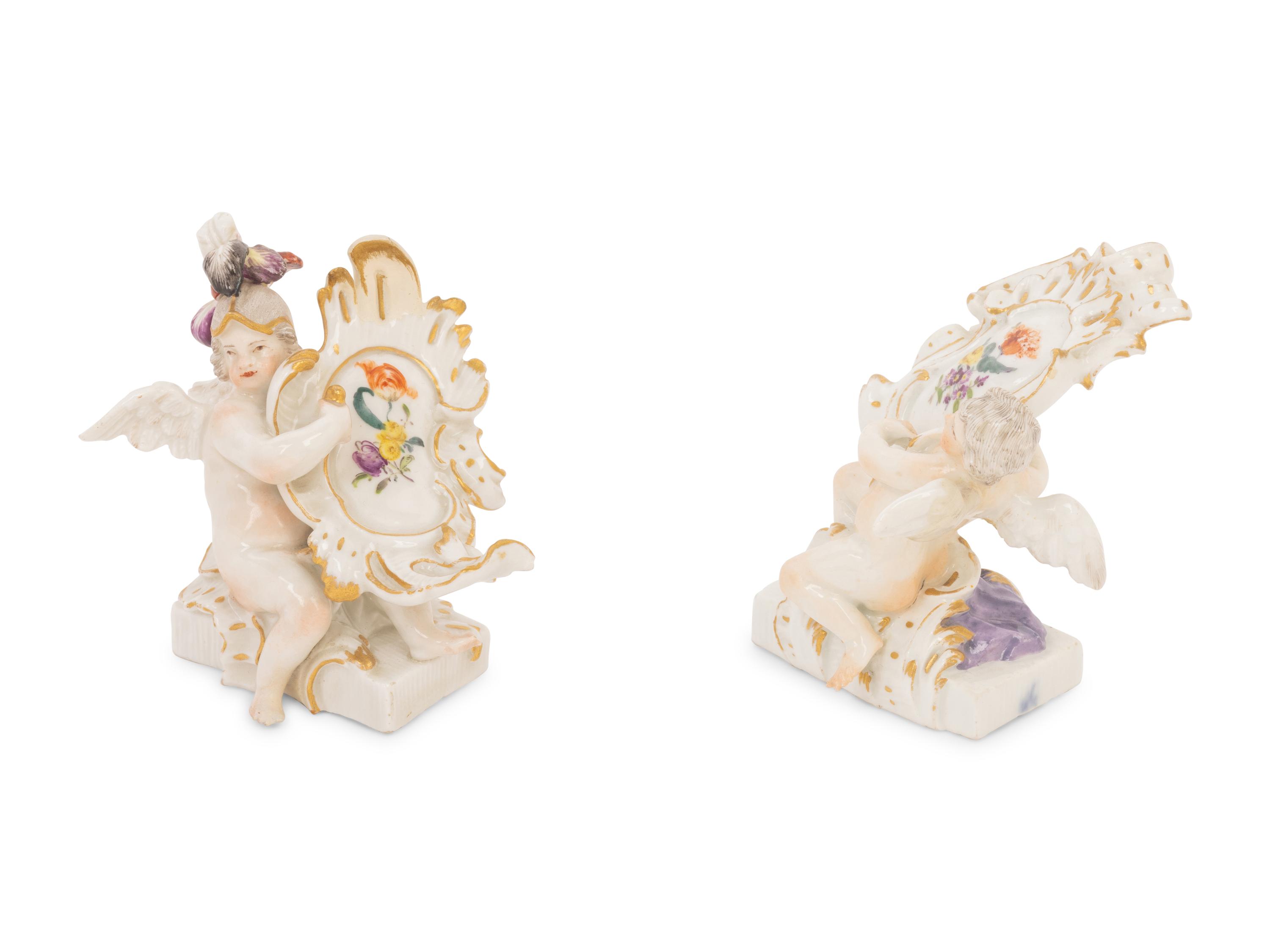 A Pair of Meissen Porcelain Figures of Putti with Cartouches