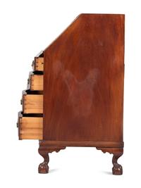 A Chippendale Carved and Figured Mahogany Reverse-Serpentine Claw-and-Ball Foot Slant-Front Desk