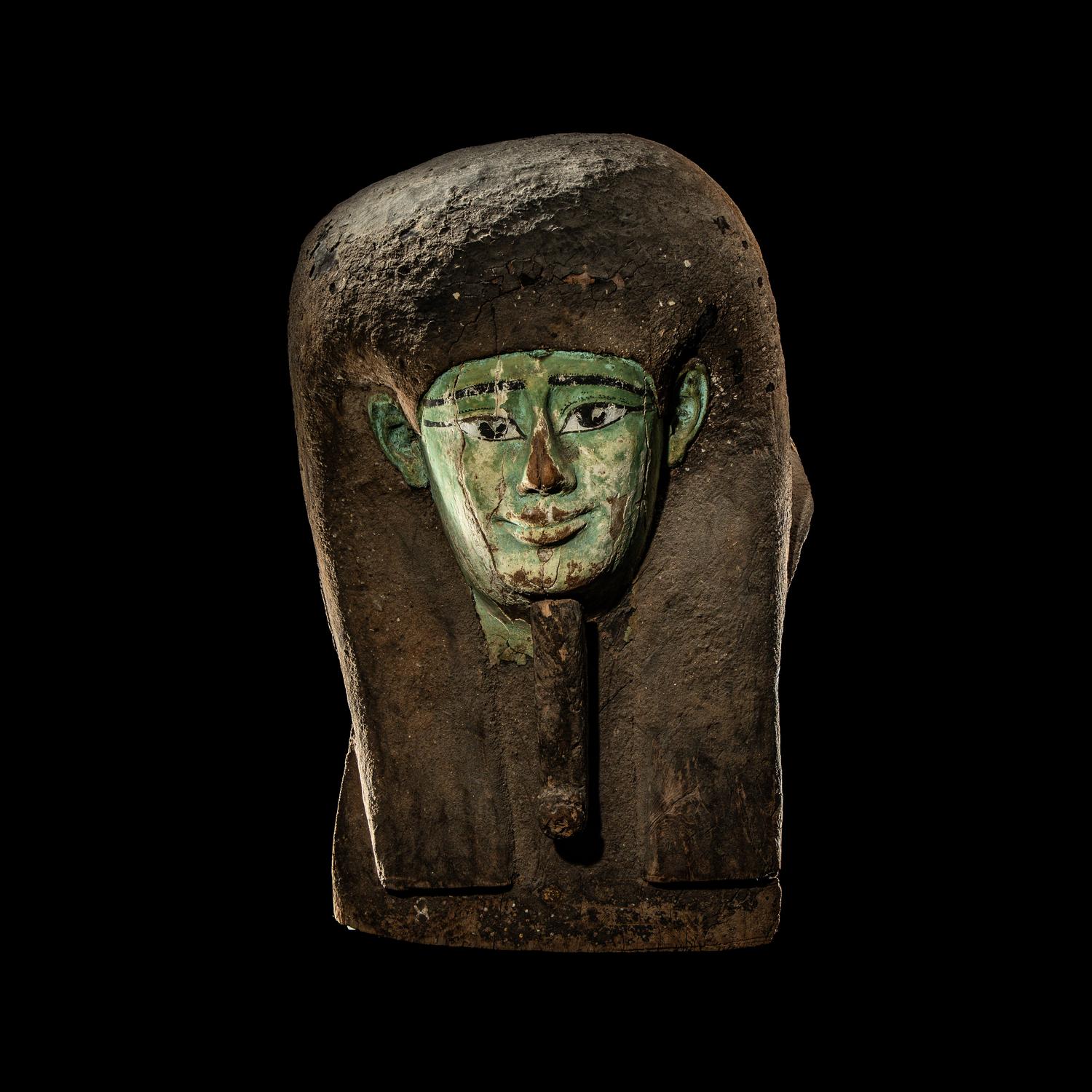 An Egyptian Painted Wood Sarcophagus Head