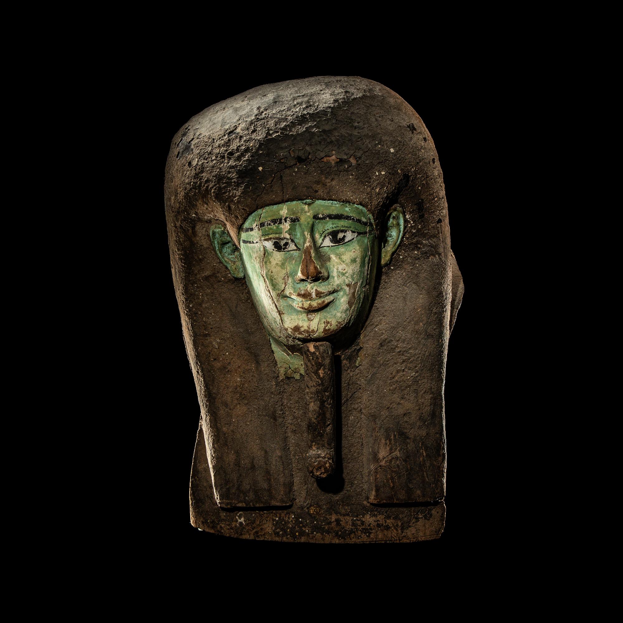An Egyptian Painted Wood Sarcophagus Head