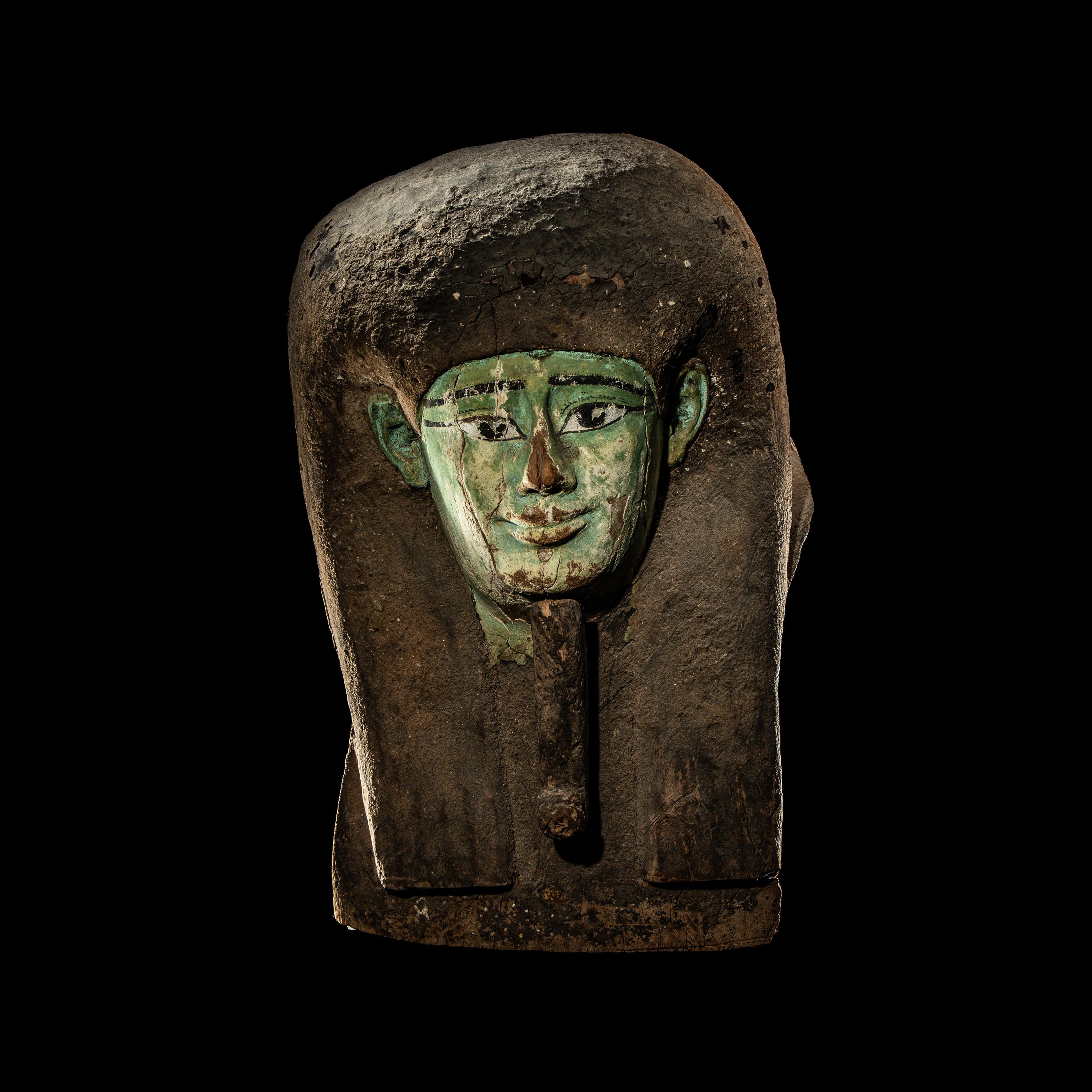 An Egyptian Painted Wood Sarcophagus Head