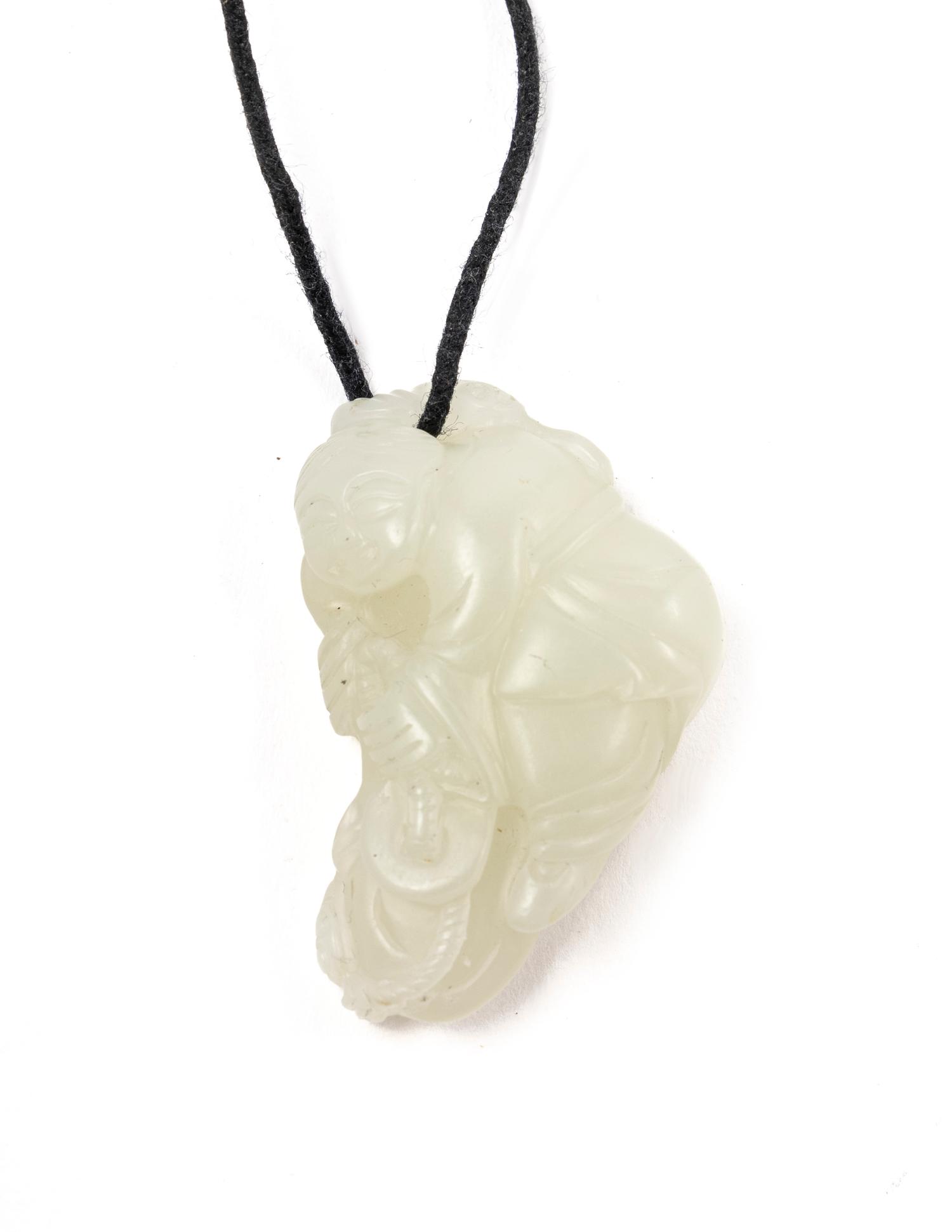 A Chinese Pale Celadon Jade Figure of a Child