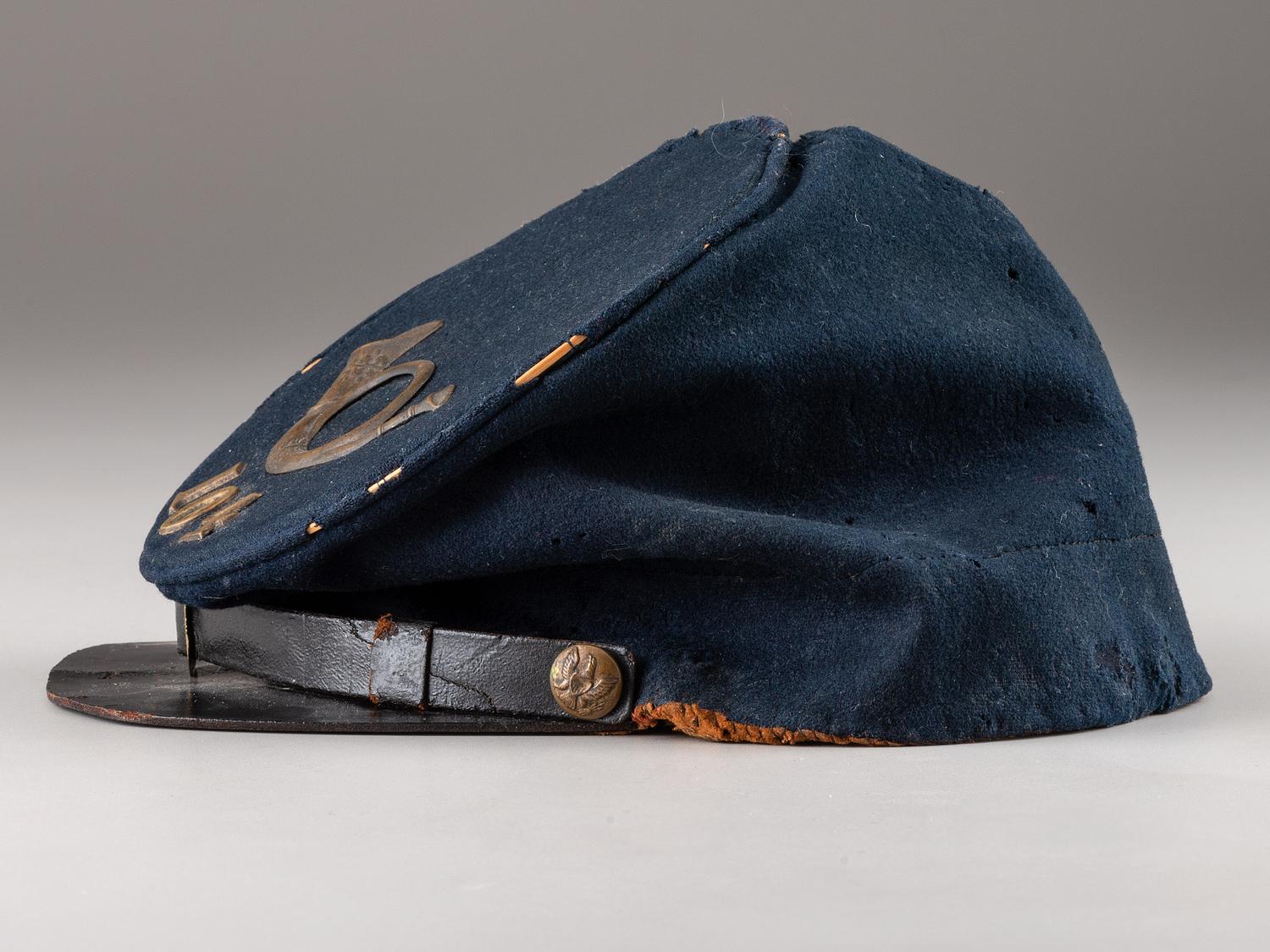 [CIVIL WAR]. Forage cap with contractor label featuring 104th regimental number and insignia.