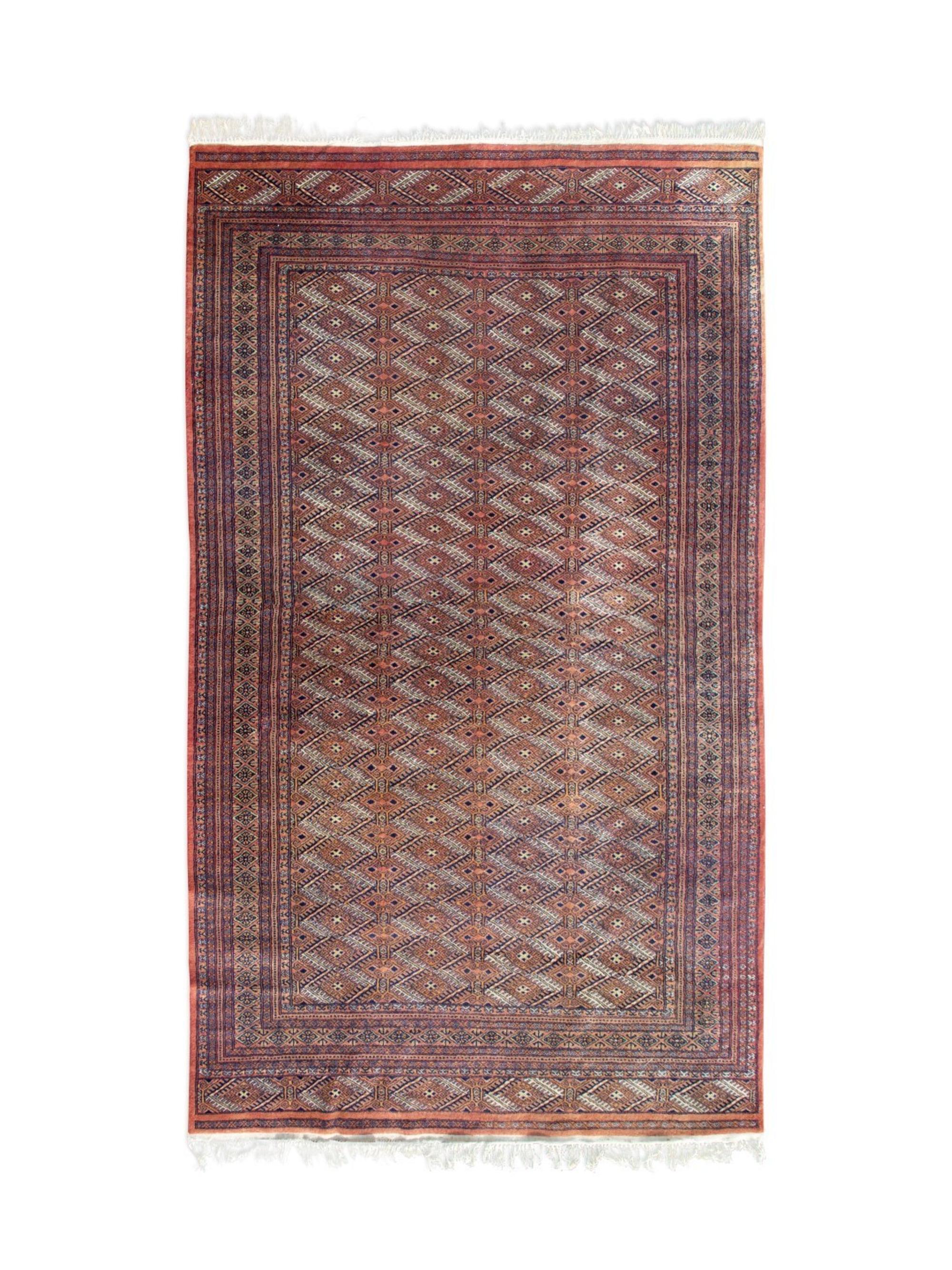 A Pakistani Wool Rug — 20TH CENTURY