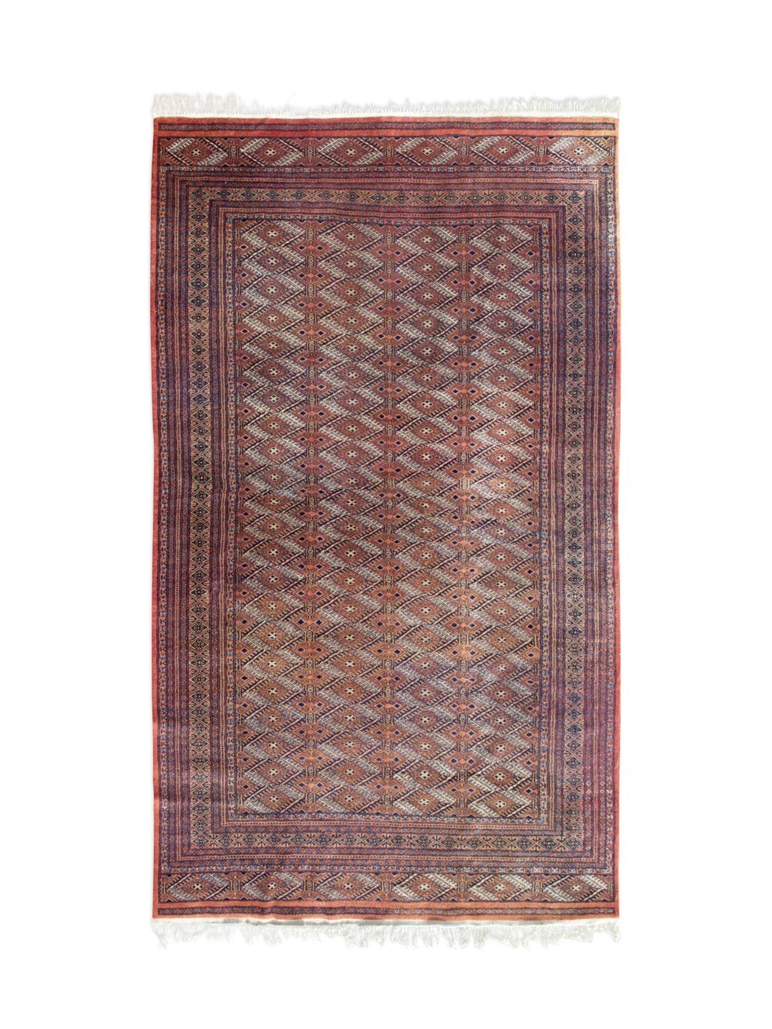 A Pakistani Wool Rug — 20TH CENTURY