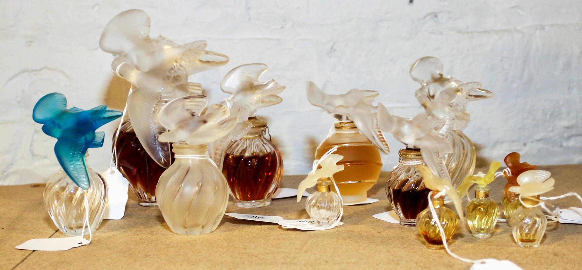 A Collection of Twelve Molded and Frosted Glass Perfume Bottles Height of tallest 6 inches.