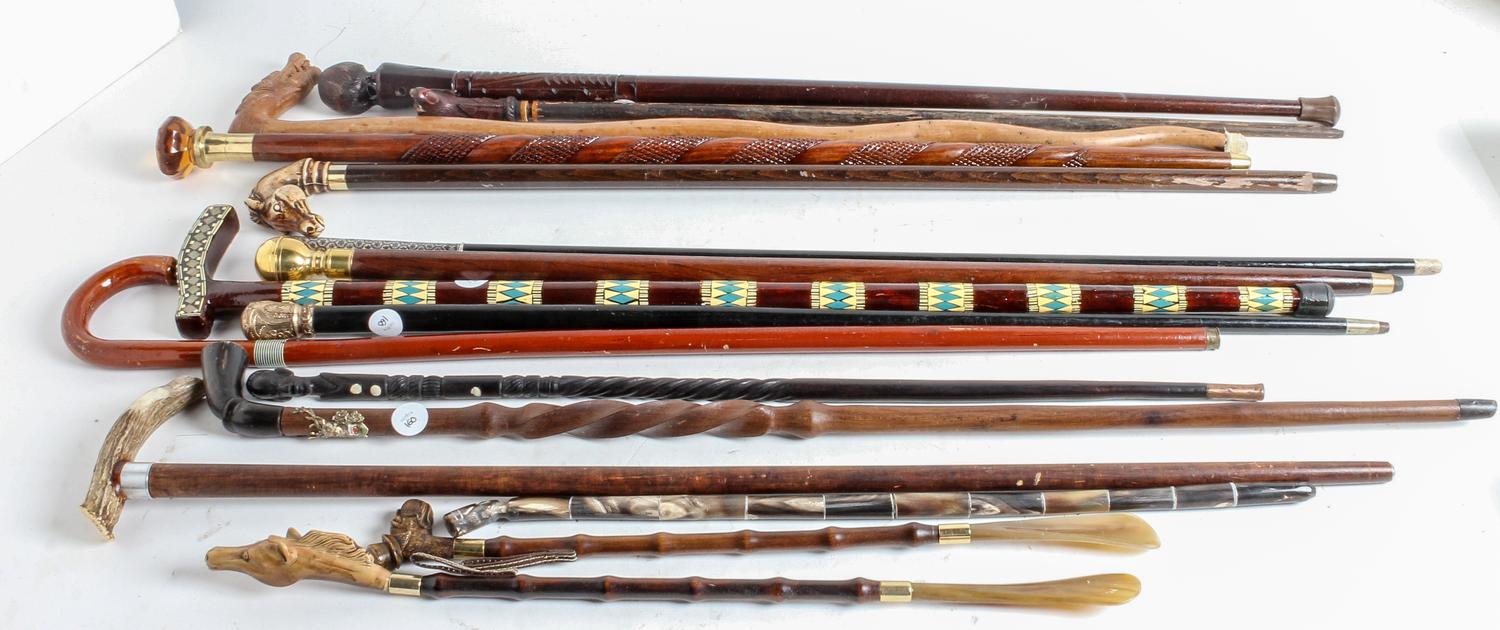 A Collection of Carved Wood and Gilt-Metal Topped Walking Canes Height of tallest 38 inches.
