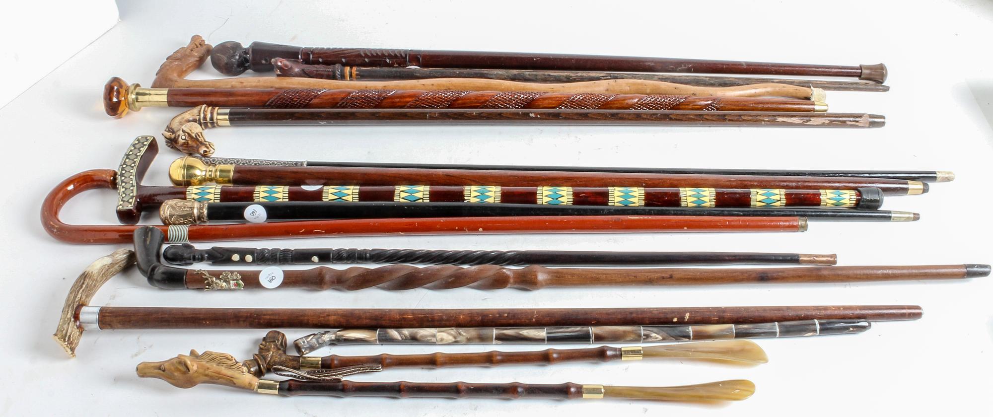 A Collection of Carved Wood and Gilt-Metal Topped Walking Canes Height of tallest 38 inches.