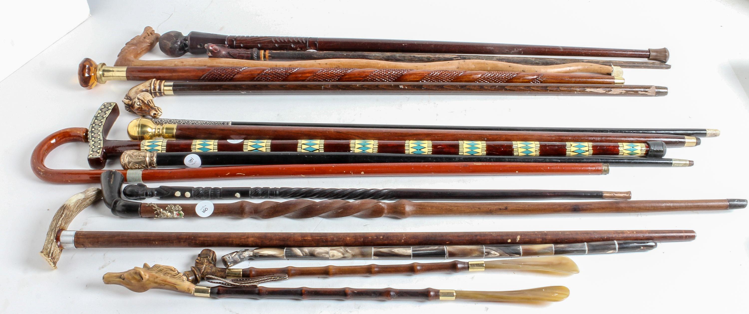 A Collection of Carved Wood and Gilt-Metal Topped Walking Canes Height of tallest 38 inches.