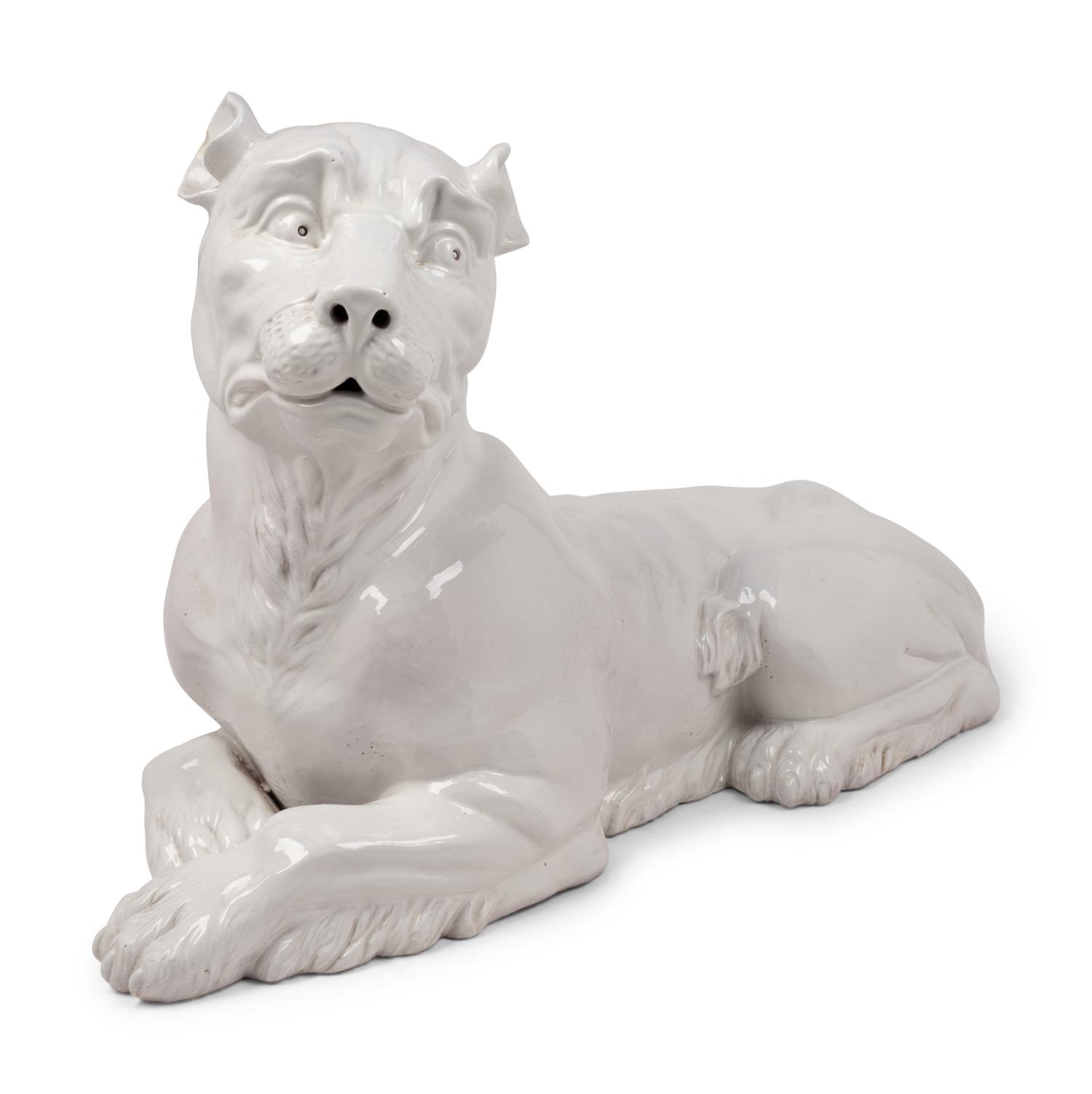 An Italian Painted Terra Cotta Figure of a Recumbent Dog