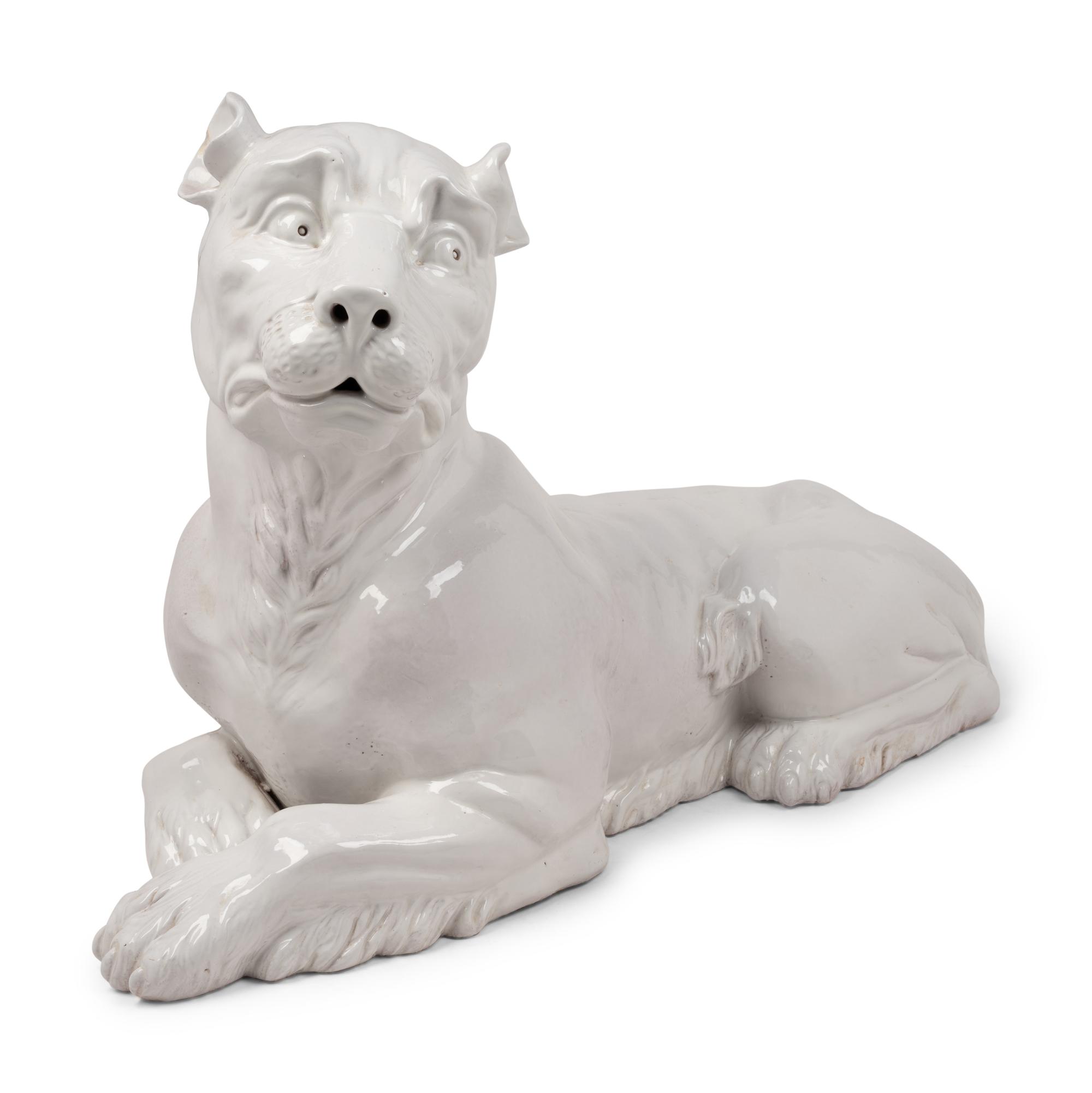 An Italian Painted Terra Cotta Figure of a Recumbent Dog