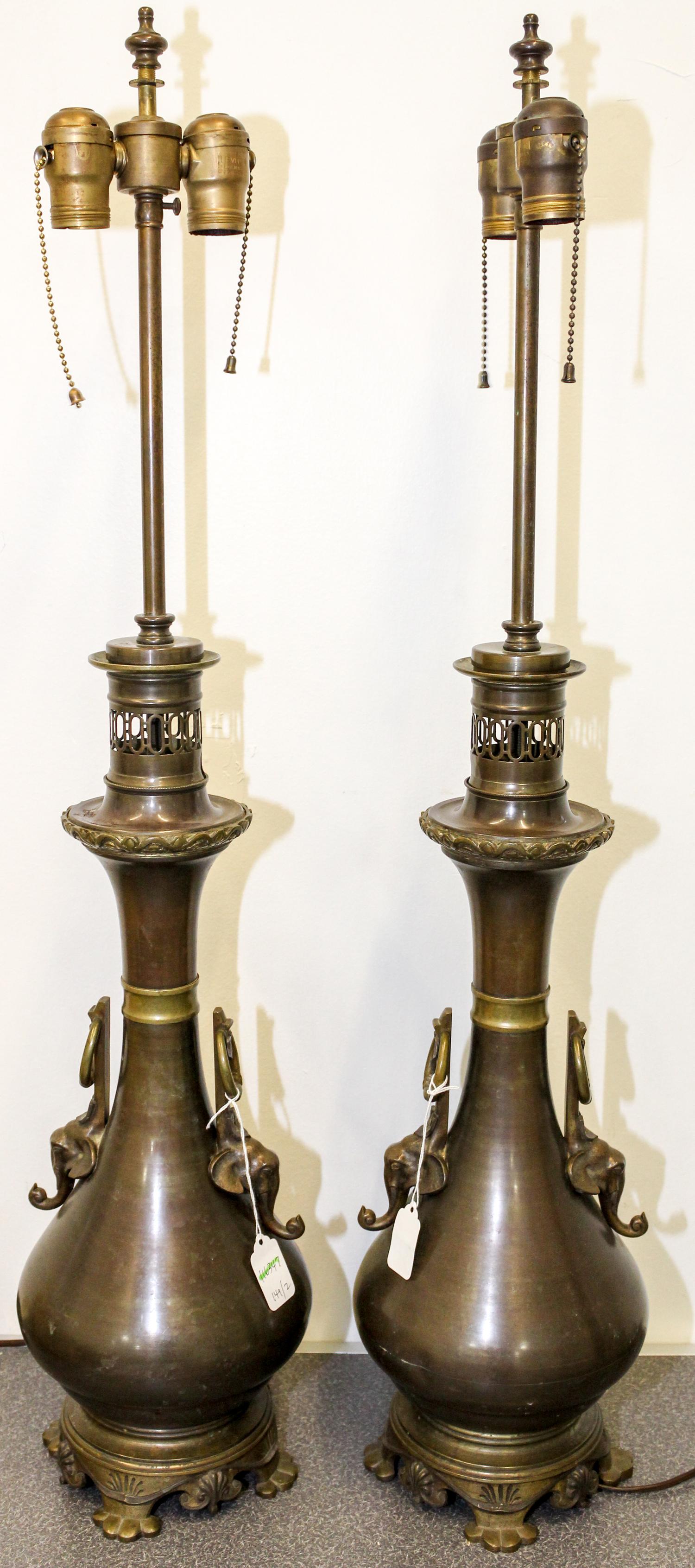 A Pair of Cast Metal Table Lamps Height 34 1/4 inches.