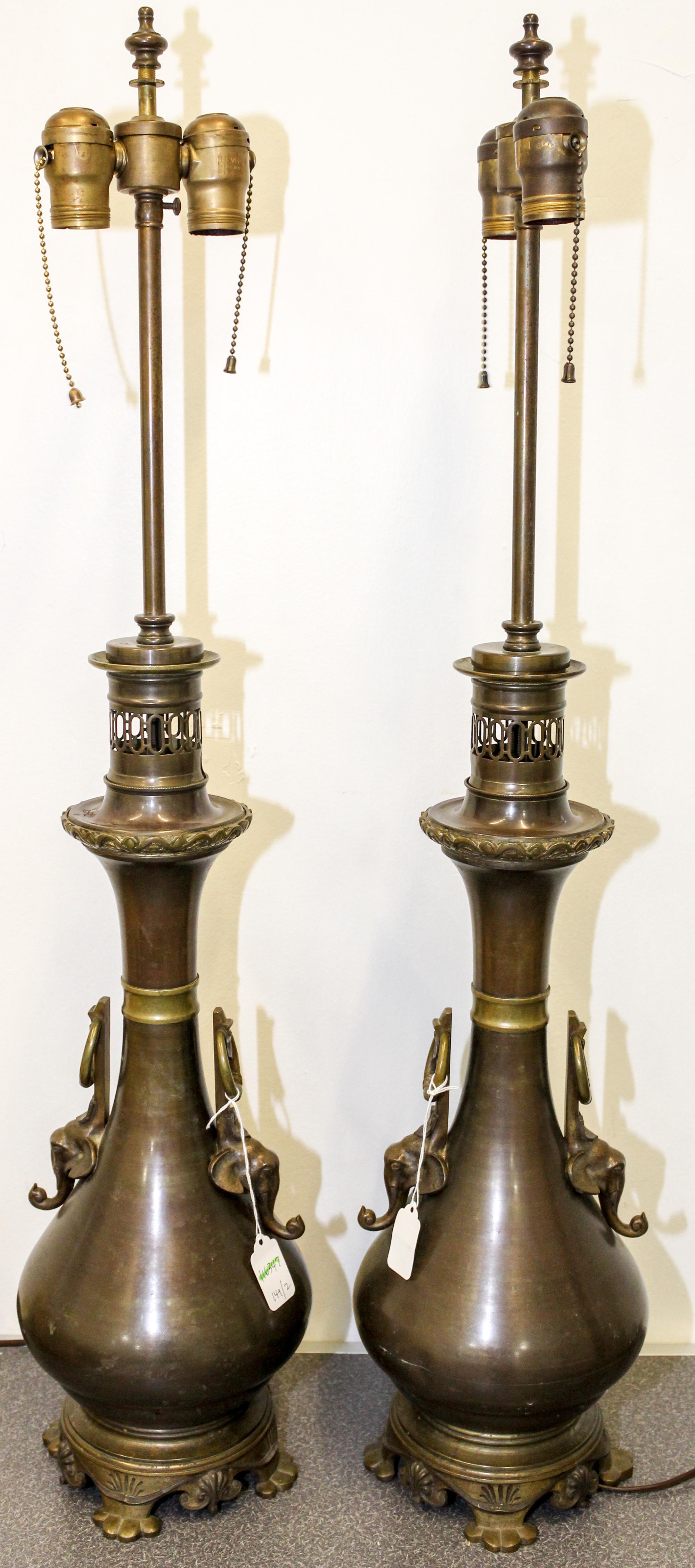 A Pair of Cast Metal Table Lamps Height 34 1/4 inches.
