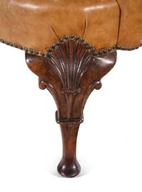 A Georgian Style Faux Leather Upholstered Walnut Wing Chair