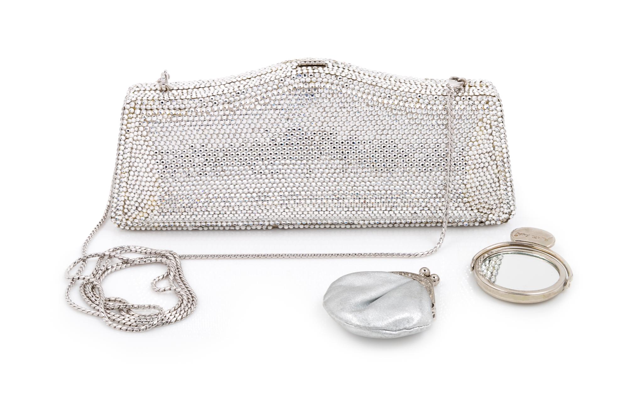 A Judith Leiber Silver Crystal Minaudiere, 3.5" H x 8" W x 1.25" D.