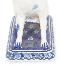 A Delft Blue and White Seated Dog and a Recumbent Cow