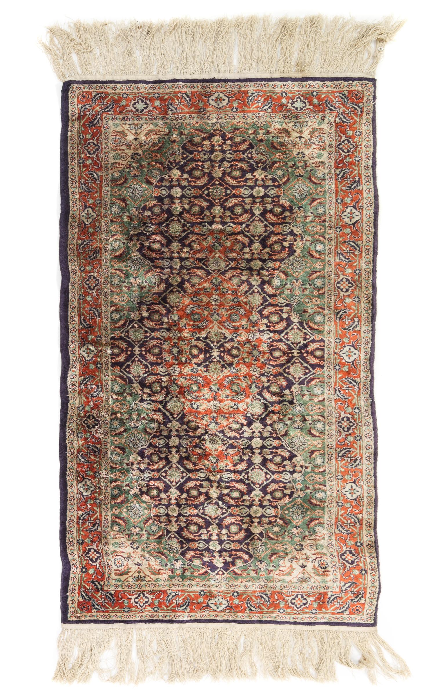 A Silk and Wool Blend Rug 4 feet 1/2 inches x 2 feet 1/2 inches.